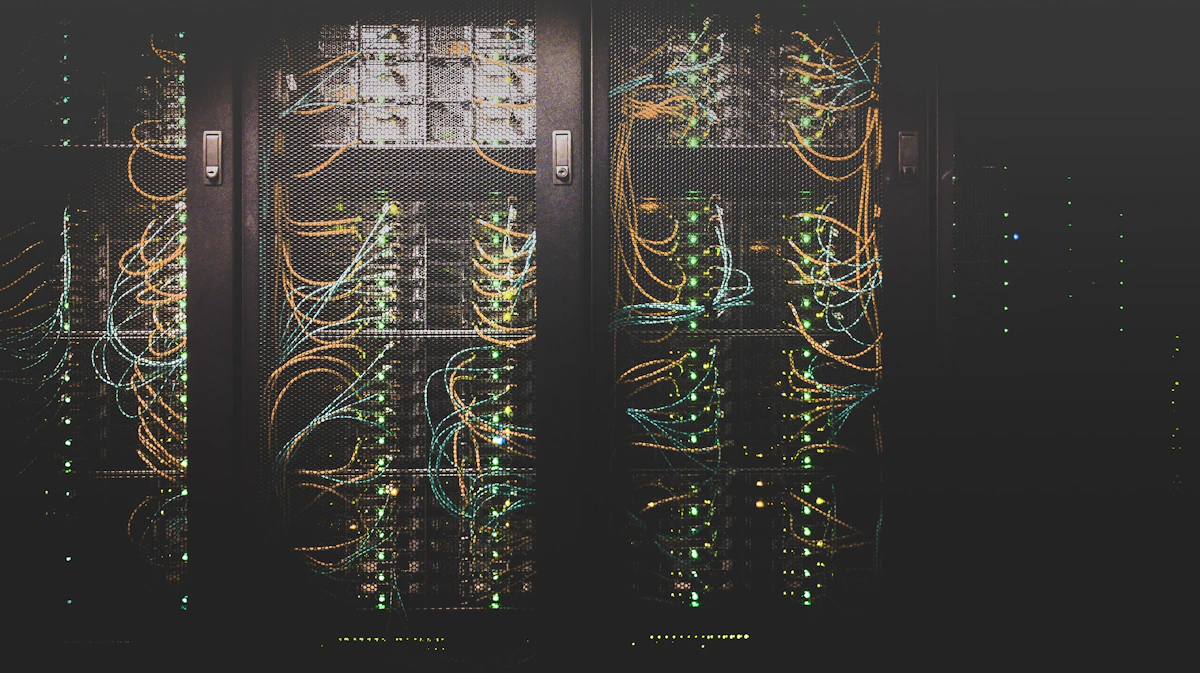 Sala de servidores com corredores de racks iluminados em tons frios